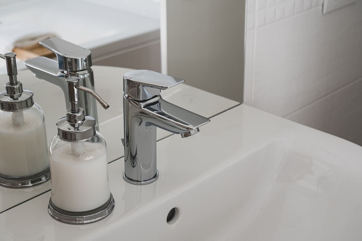 Chrome faucet on a white bathroom sink