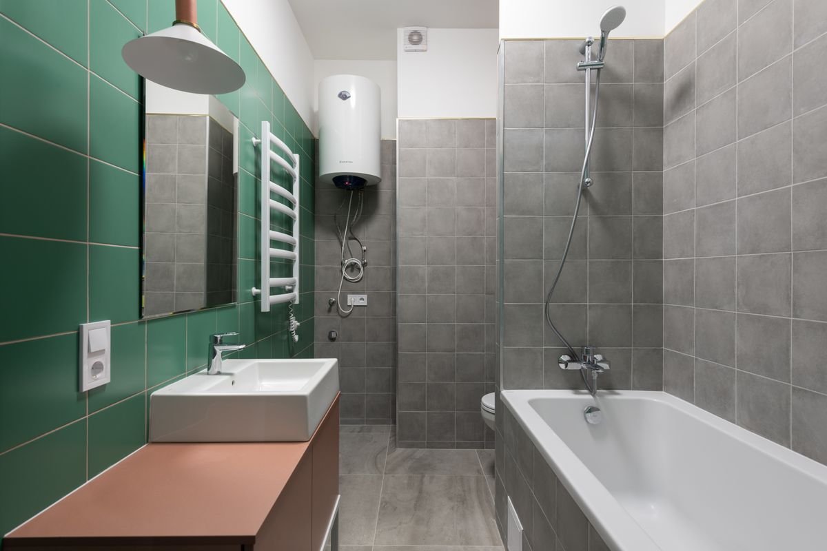 Modern bathroom with tiled walls and bathtub