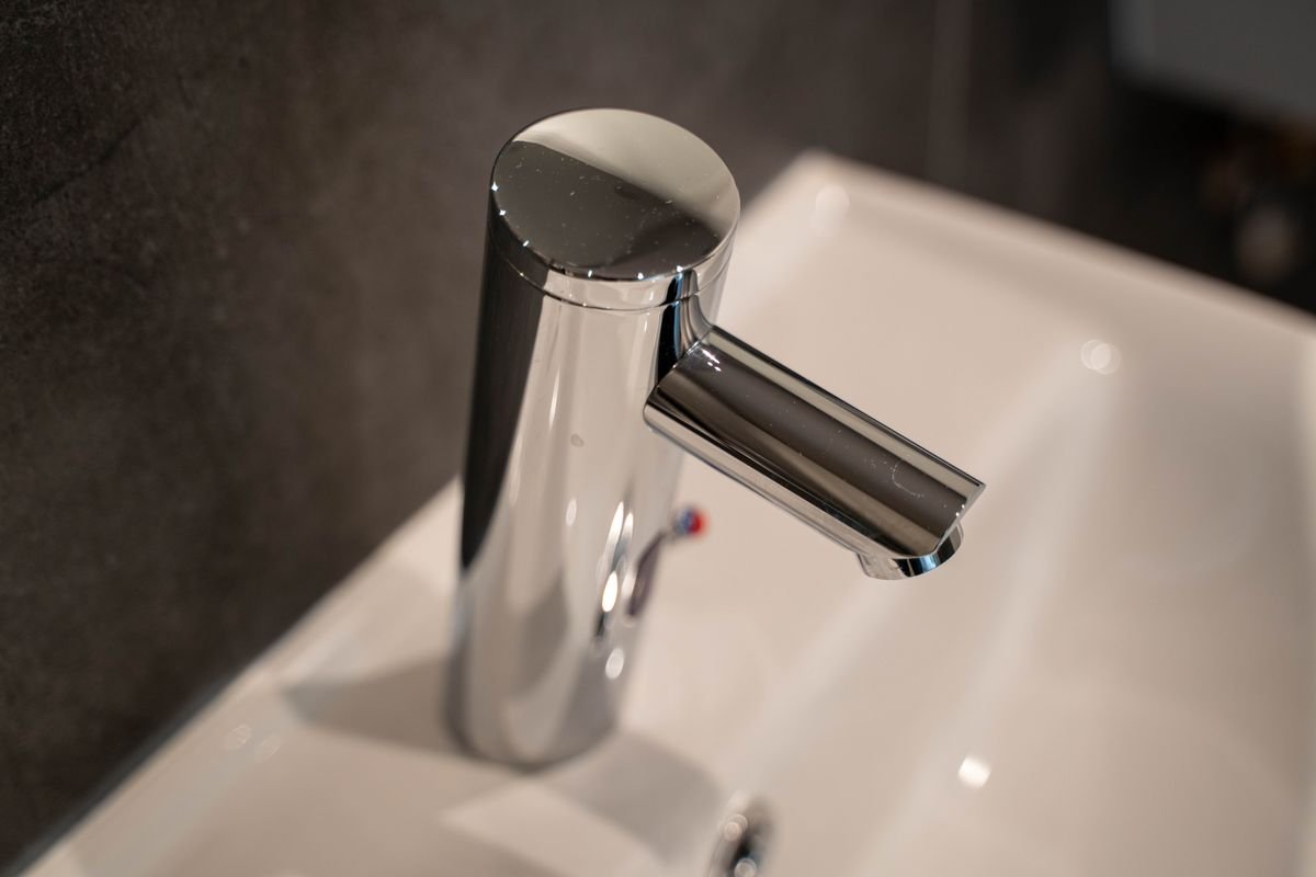 Stainless steel faucet on a ceramic sink