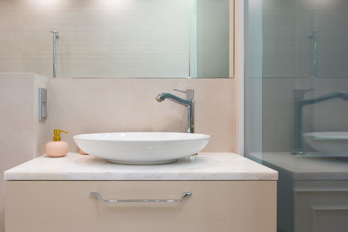 Light modern washroom with sink and mirror