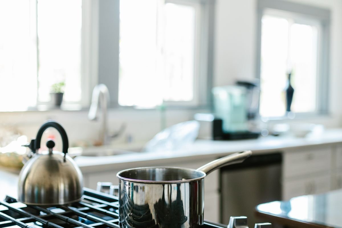 Bright kitchen with pot and kettle on a gas hob