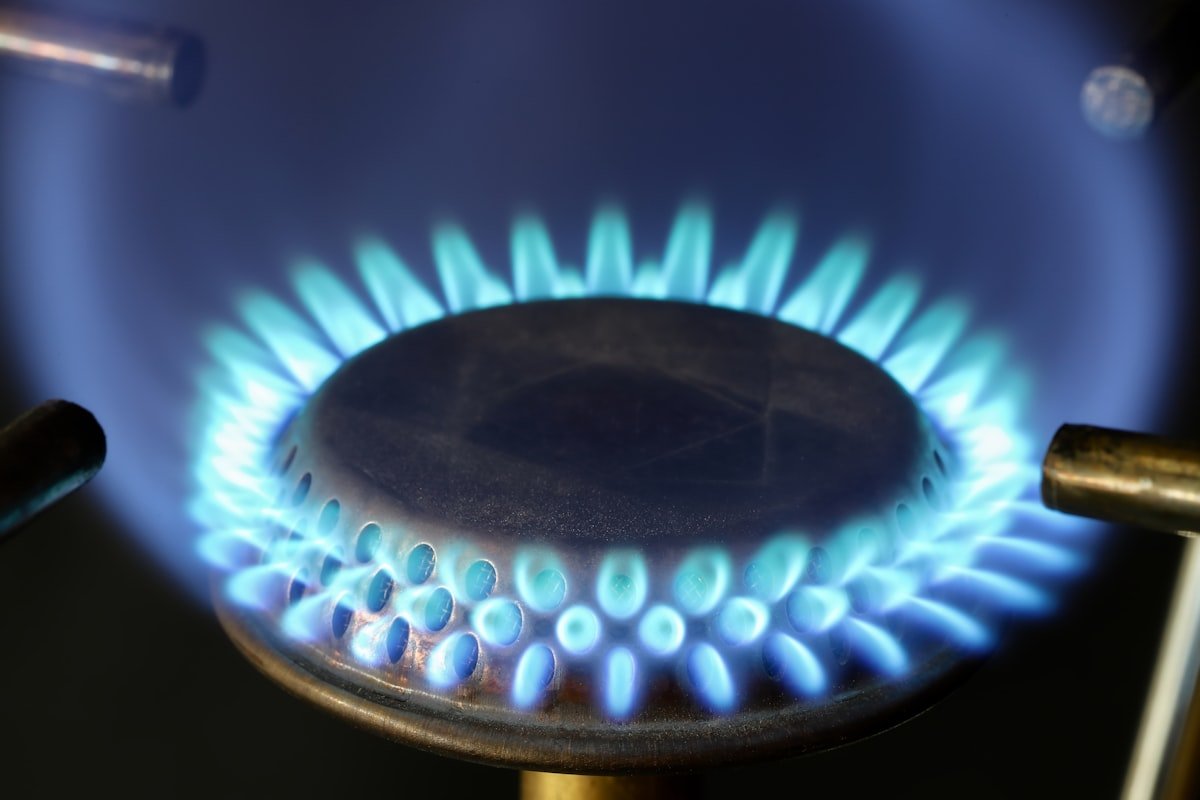 Close-up blue flame on a gas hob burner