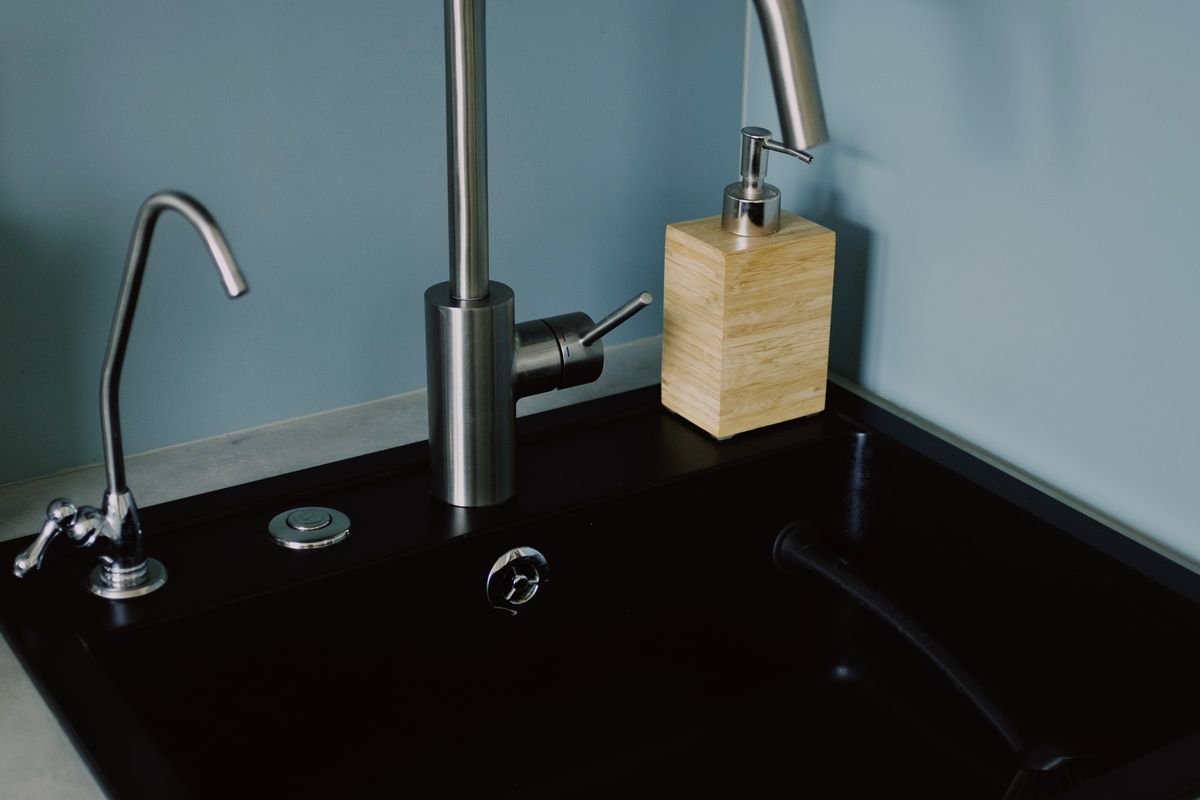 Black kitchen sink with stainless steel tap