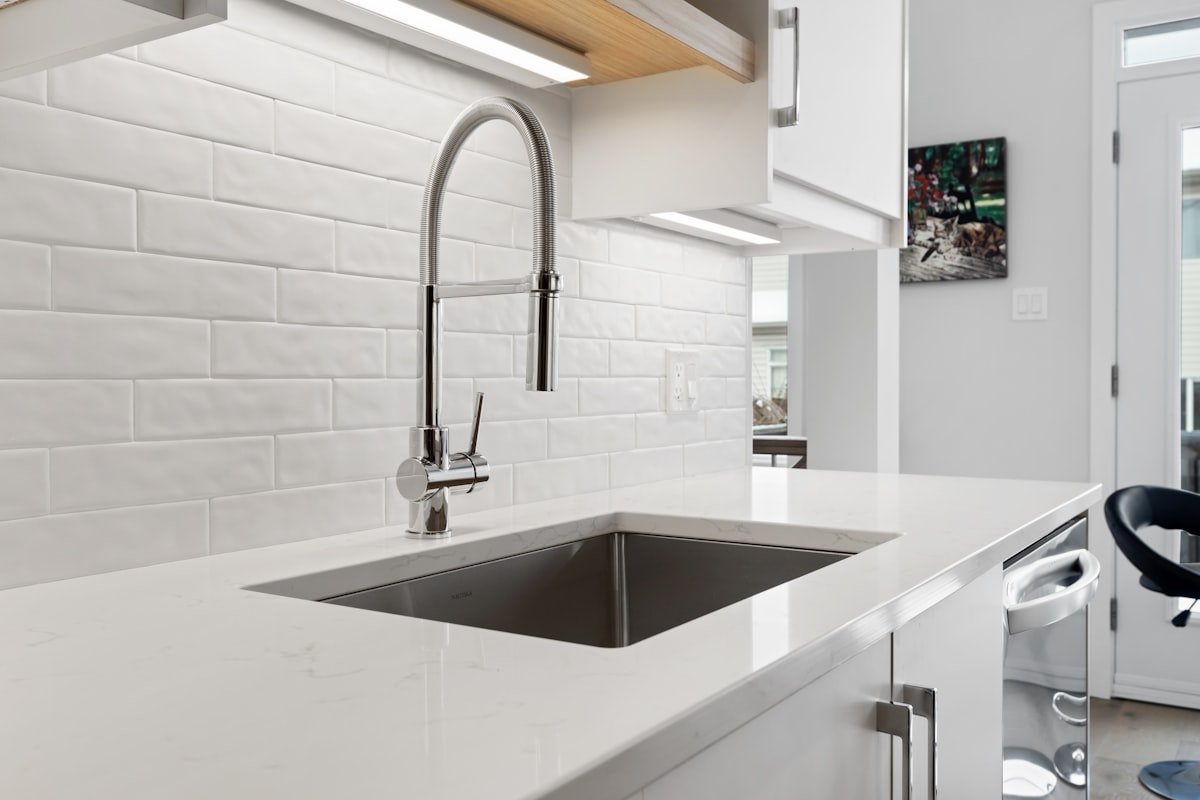 Kitchen sink installed beneath a window