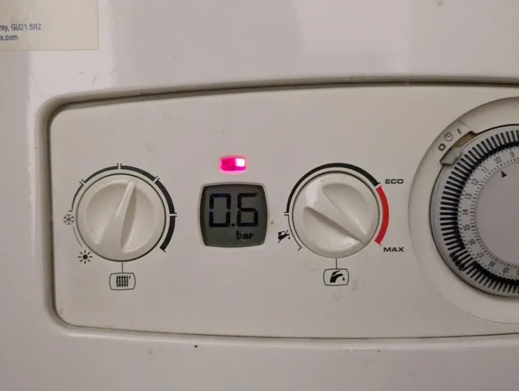 Boiler pressure gauge showing low pressure in a UK home